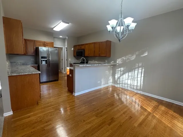 a view of a kitchen with a sink and dishwasher a refrigerator freezer