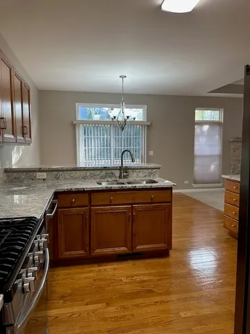a kitchen with granite countertop a stove and a sink