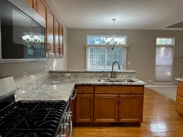 a kitchen with granite countertop stove and cabinets