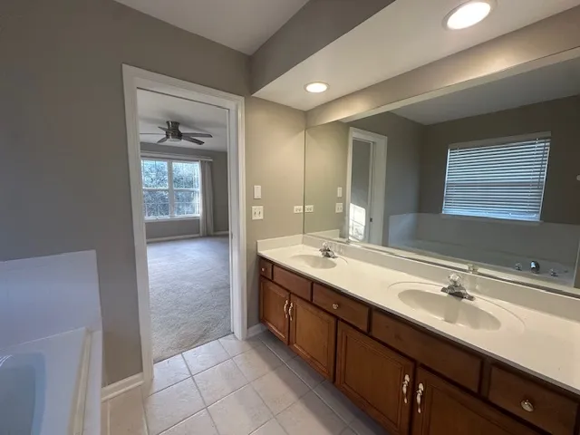 a bathroom with a double vanity sink and mirror