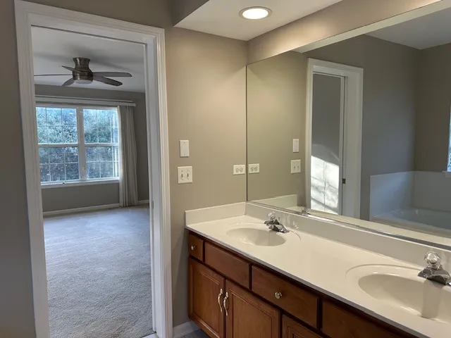 a bathroom with a sink double vanity and a mirror