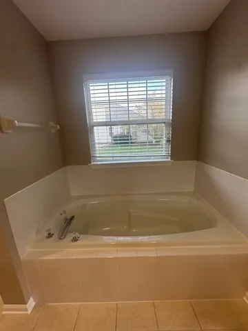 a white bath tub sitting next to a window