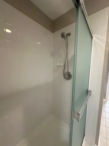 a bathroom with a glass shower door