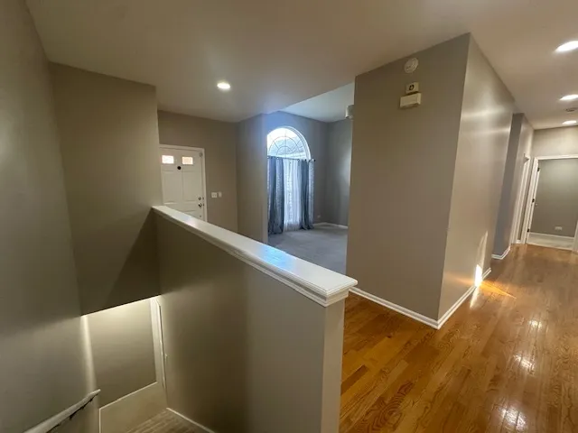 a view of a hallway with wooden floor