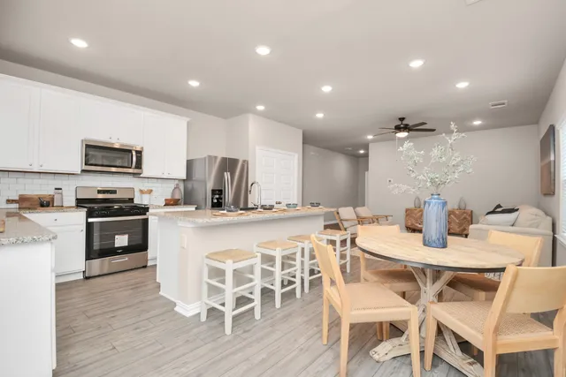 a living room with furniture and kitchen view
