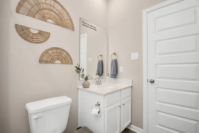 a kitchen with stainless steel appliances a dining table chairs and wooden floor