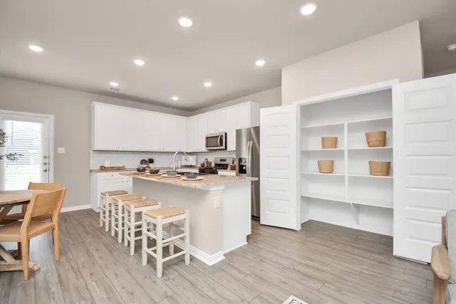 a en suite bathroom with a double vanity sink and a mirror