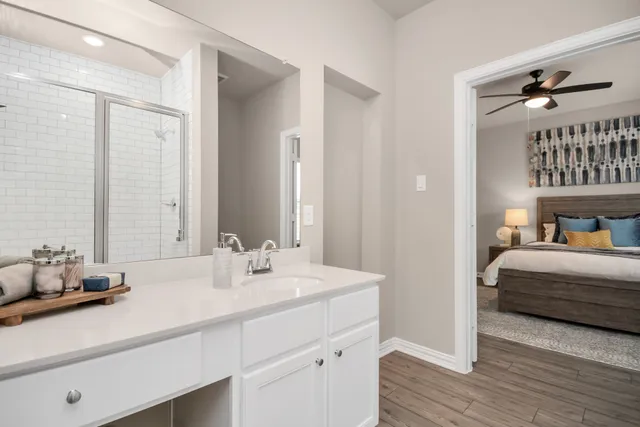 an aerial view of a swimming pool with a yard and seating