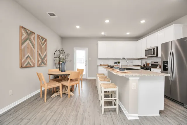 a living room with furniture and kitchen view