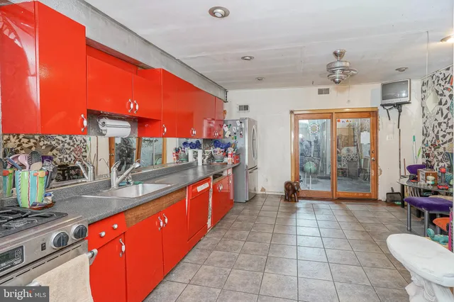 a large kitchen with stainless steel appliances granite countertop a sink counter space and a dining table