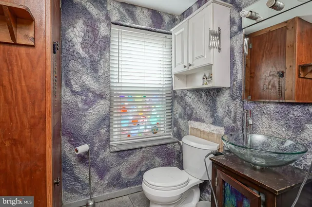a bathroom with a toilet a sink and a shower