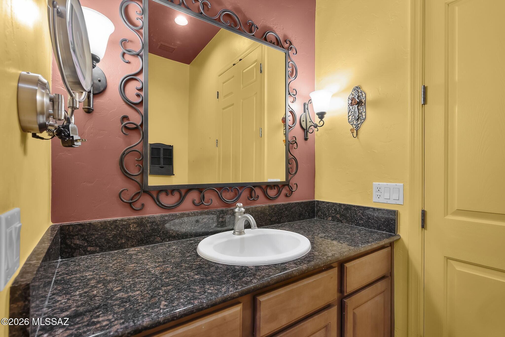 101 Post Way Tubac, AZ 85646 - Photo 17 of 31 a bathroom with a granite countertop sink and a mirror