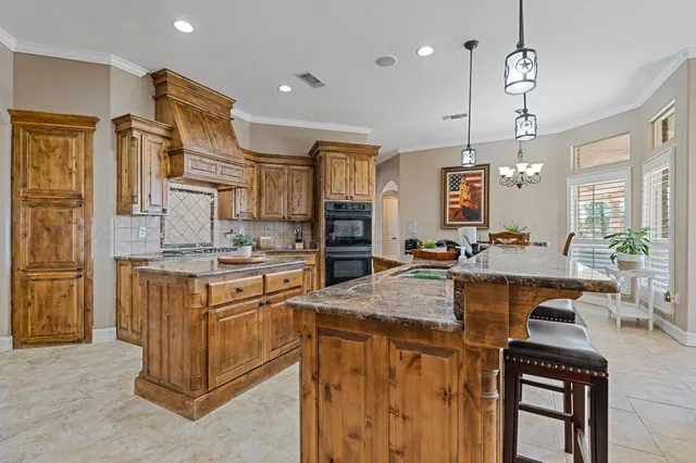 a kitchen with stainless steel appliances granite countertop a sink stove and refrigerator