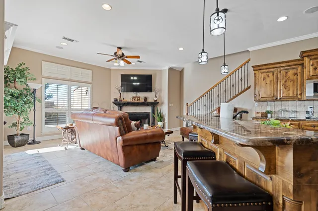 a living room with furniture a fireplace and a flat screen tv
