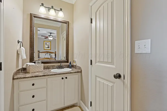 a kitchen with granite countertop white cabinets and a stove