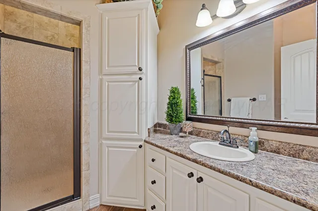 a bathroom with a tub a sink and mirror