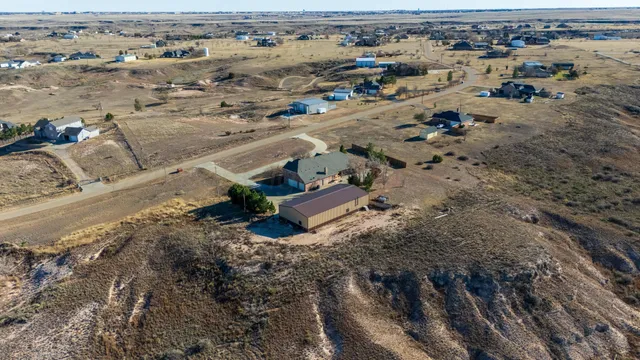 an aerial view of a house with a yard