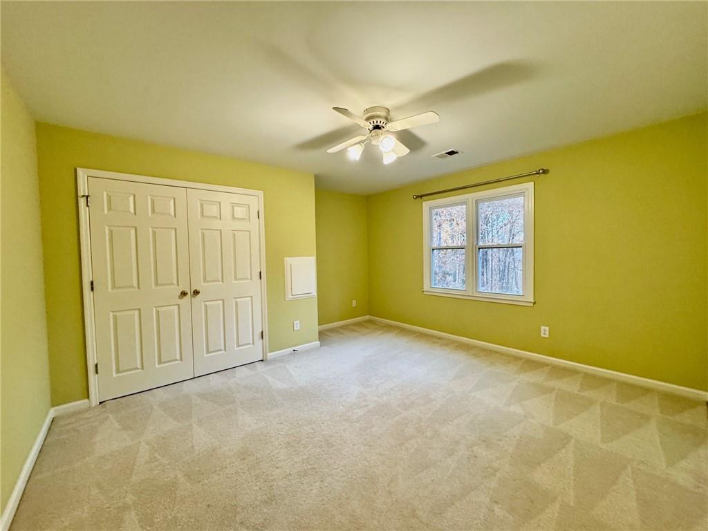 5450 Heathridge Terrace Johns Creek, GA 30097 - Photo 13 of 30 an empty room with windows and ceiling fan view