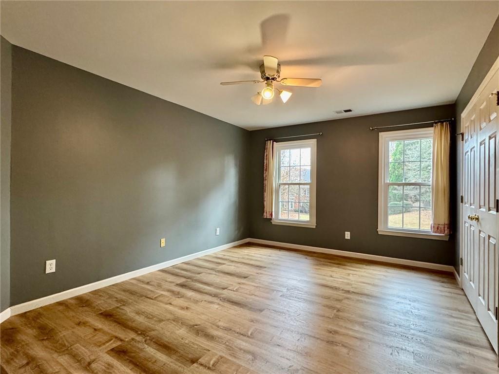 5450 Heathridge Terrace Johns Creek, GA 30097 - Photo 16 of 30 a view of an empty room with a window and wooden floor