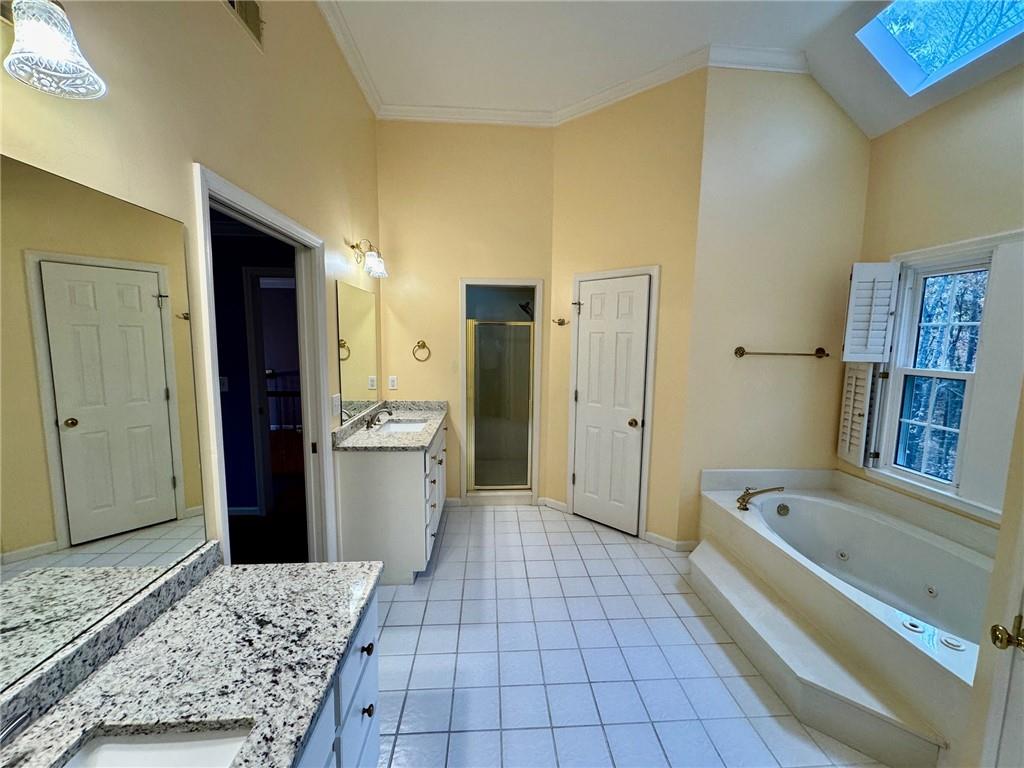 5450 Heathridge Terrace Johns Creek, GA 30097 - Photo 22 of 30 a bathroom with a bathtub and a shower