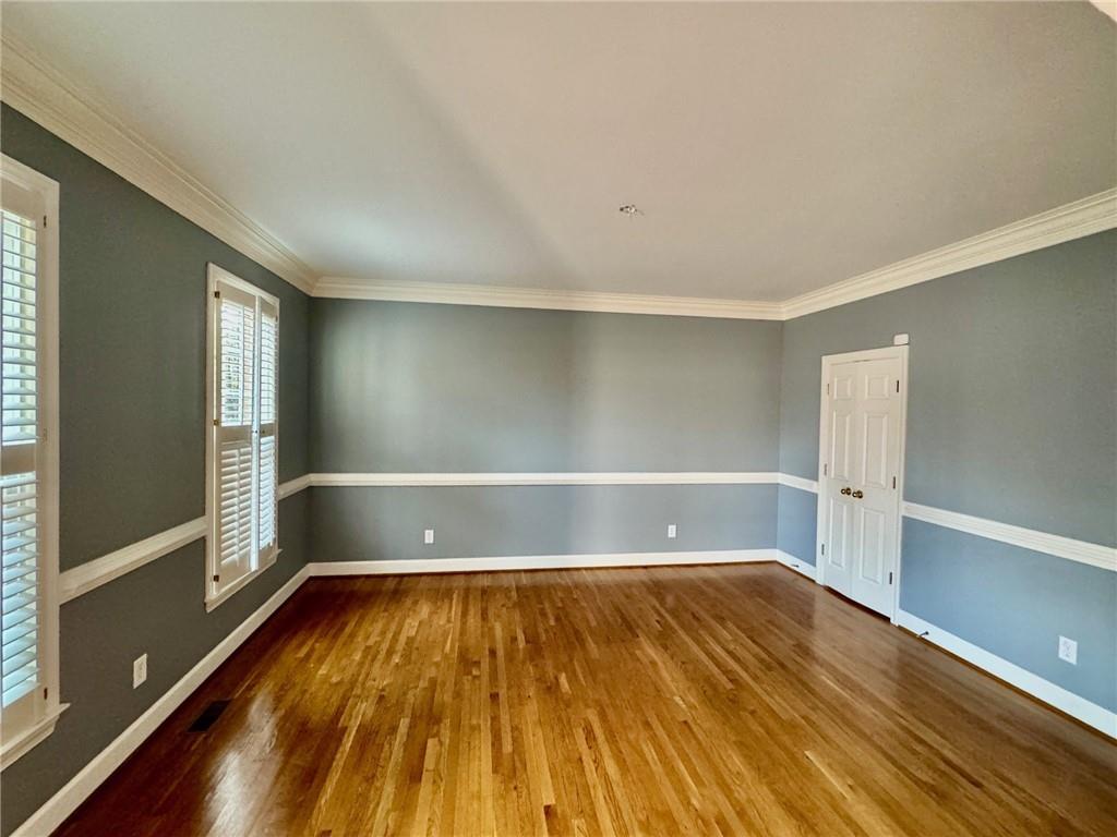 5450 Heathridge Terrace Johns Creek, GA 30097 - Photo 3 of 30 a view of a room with wooden floor and white walls