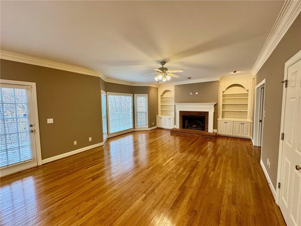 5450 Heathridge Terrace Johns Creek, GA 30097 - Photo 5 of 30 an empty room with wooden floor and fireplace