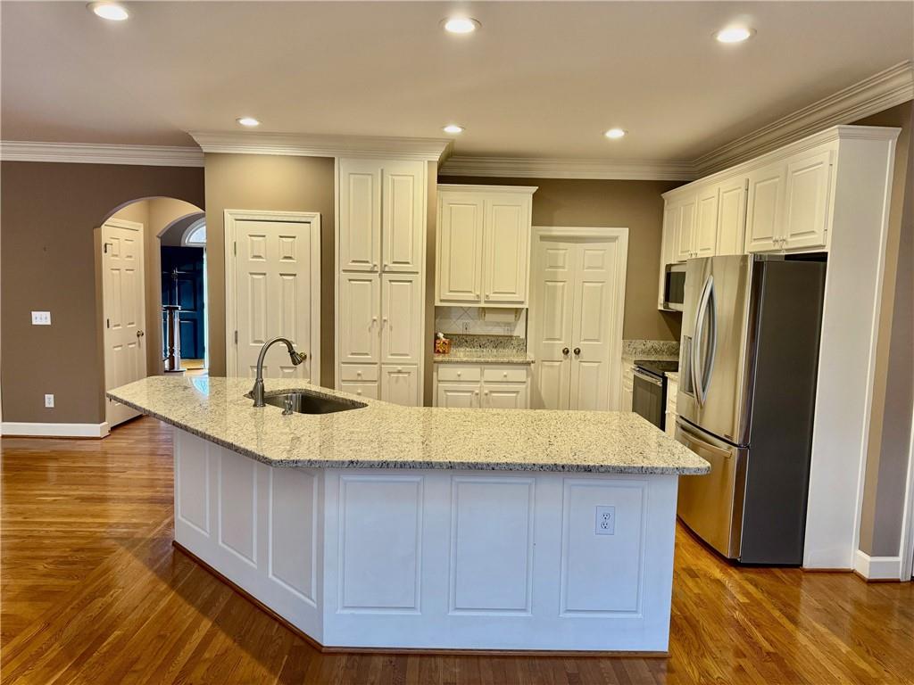 5450 Heathridge Terrace Johns Creek, GA 30097 - Photo 8 of 30 a view of kitchen with stainless steel appliances granite countertop a refrigerator and a sink