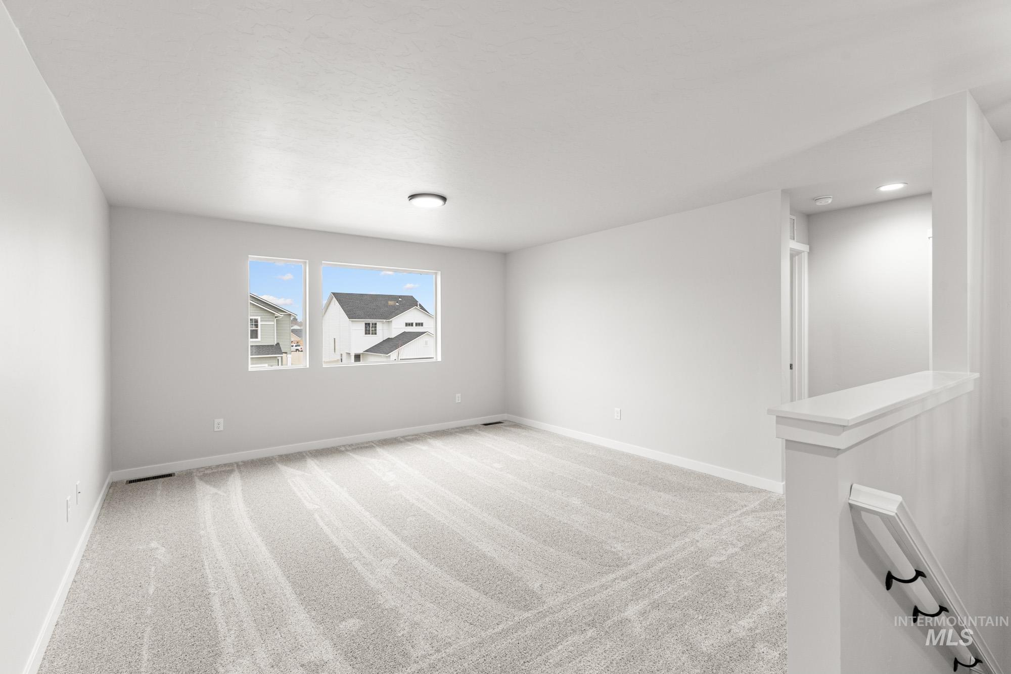 3030 South Maple Rnch Way Nampa, ID 83686 - Photo 12 of 21 Empty room with light carpet and baseboards