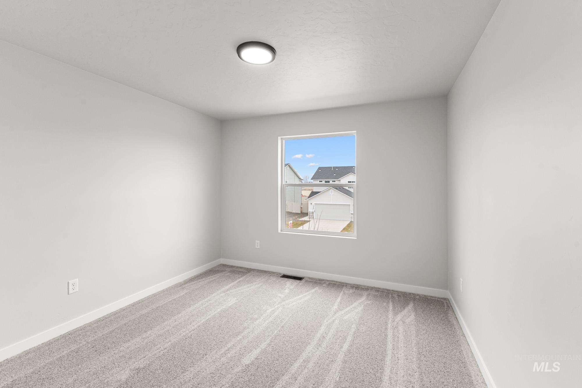 3030 South Maple Rnch Way Nampa, ID 83686 - Photo 13 of 21 Carpeted spare room with baseboards