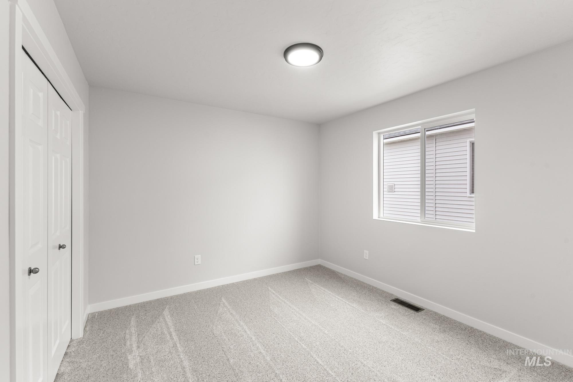 3030 South Maple Rnch Way Nampa, ID 83686 - Photo 14 of 21 Unfurnished bedroom featuring a closet and light colored carpet
