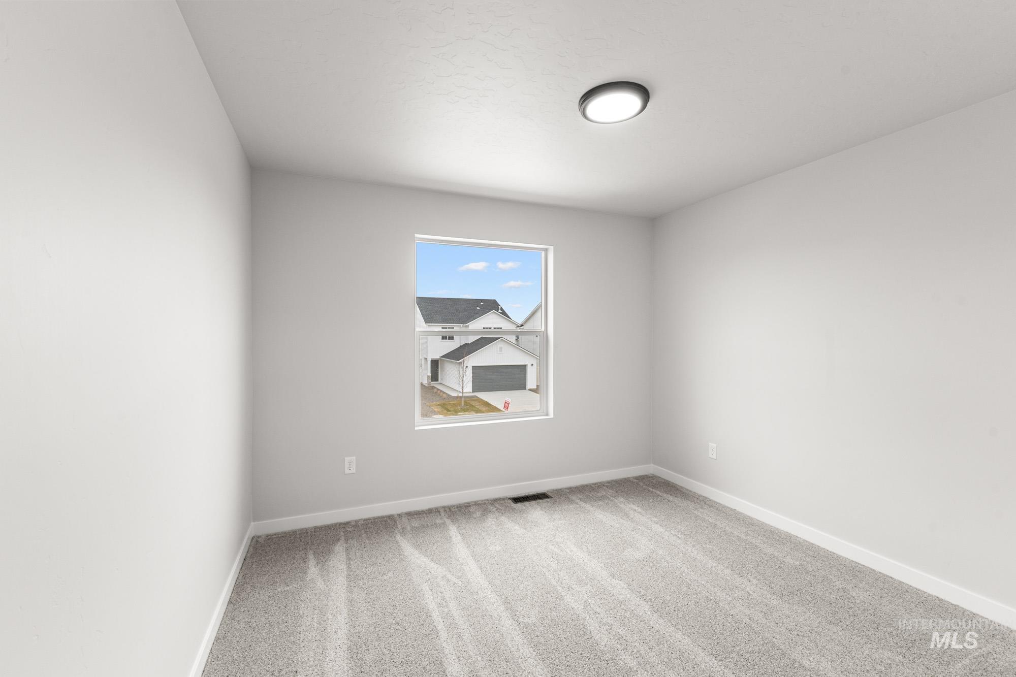 3030 South Maple Rnch Way Nampa, ID 83686 - Photo 15 of 21 Unfurnished room with light colored carpet and baseboards