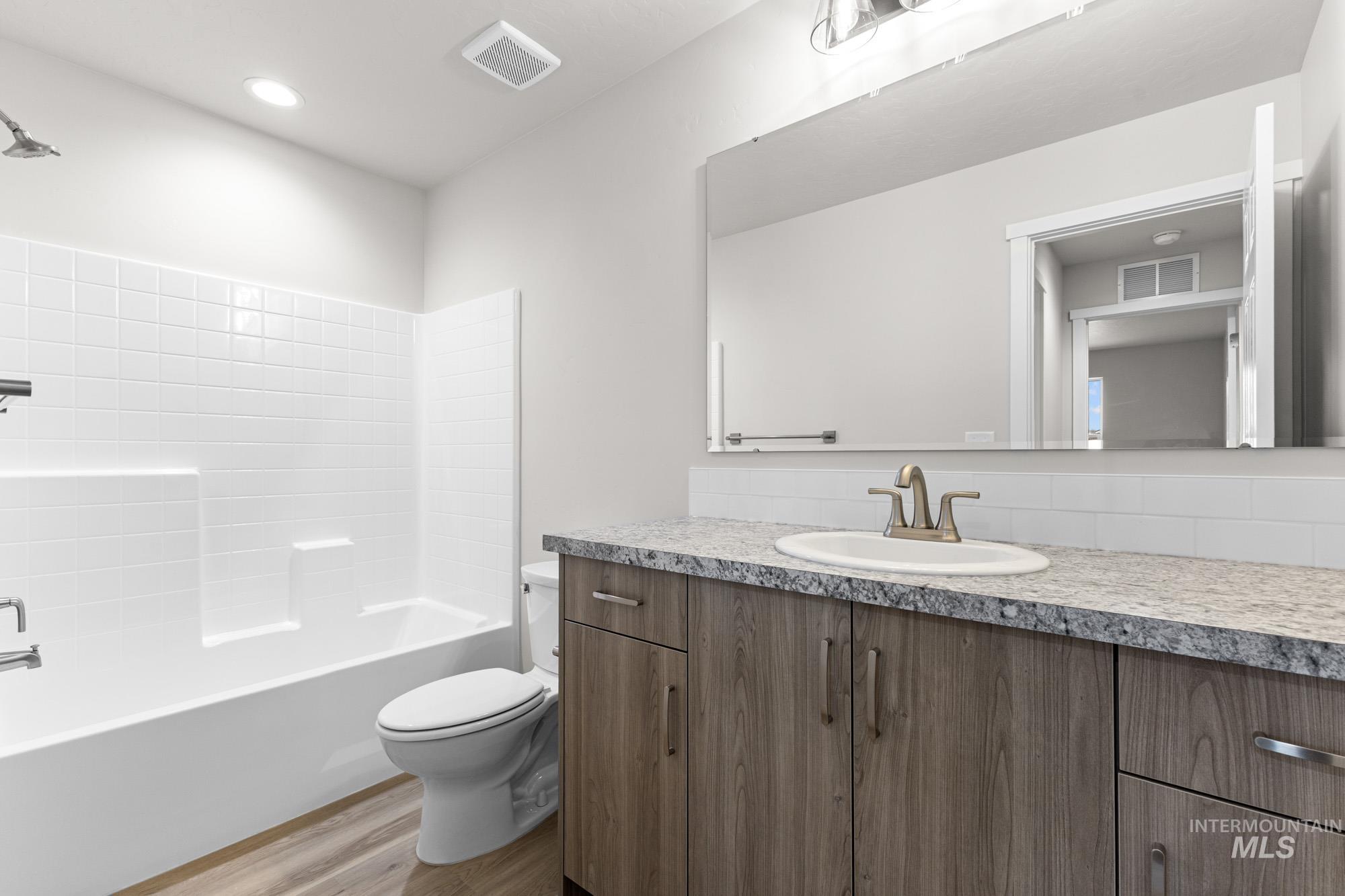 3030 South Maple Rnch Way Nampa, ID 83686 - Photo 16 of 21 Bathroom featuring vanity, shower / tub combination, and light wood-type flooring
