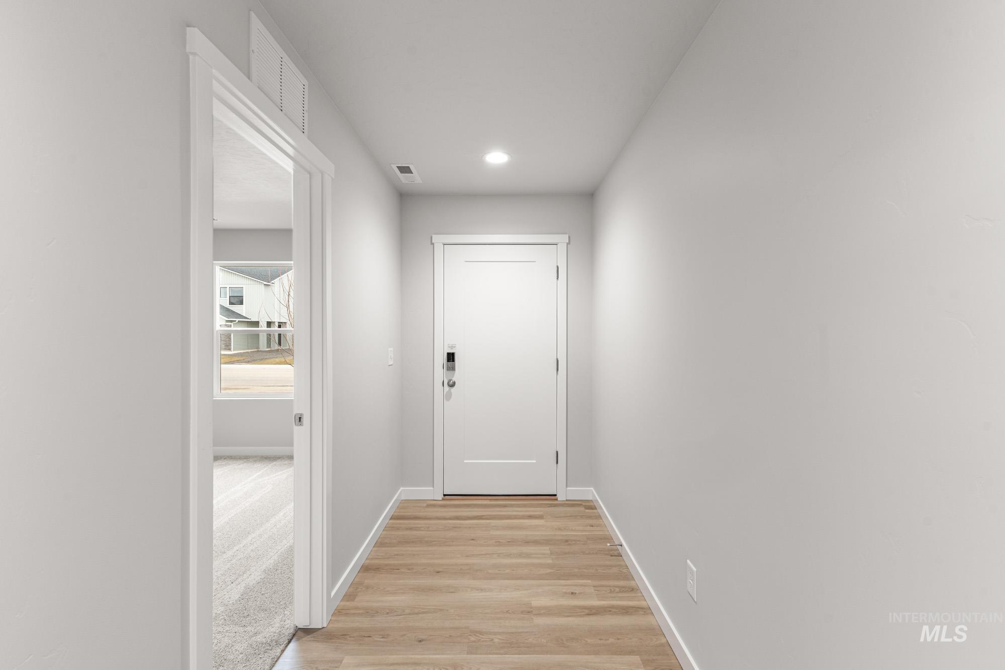 3030 South Maple Rnch Way Nampa, ID 83686 - Photo 2 of 21 Doorway to outside with wood finished floors and recessed lighting