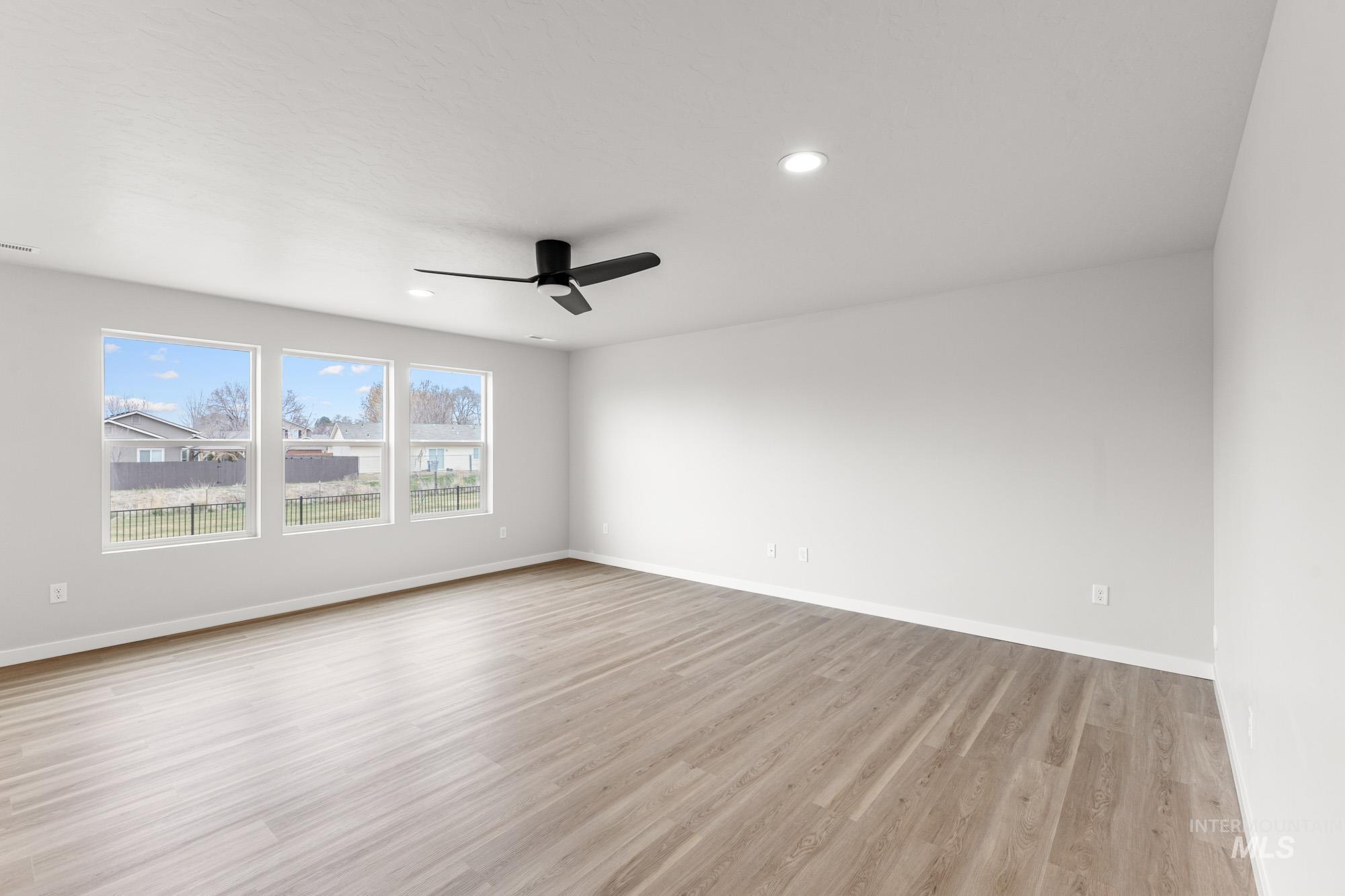 3030 South Maple Rnch Way Nampa, ID 83686 - Photo 7 of 21 Unfurnished room featuring a ceiling fan, light wood-type flooring, and recessed lighting