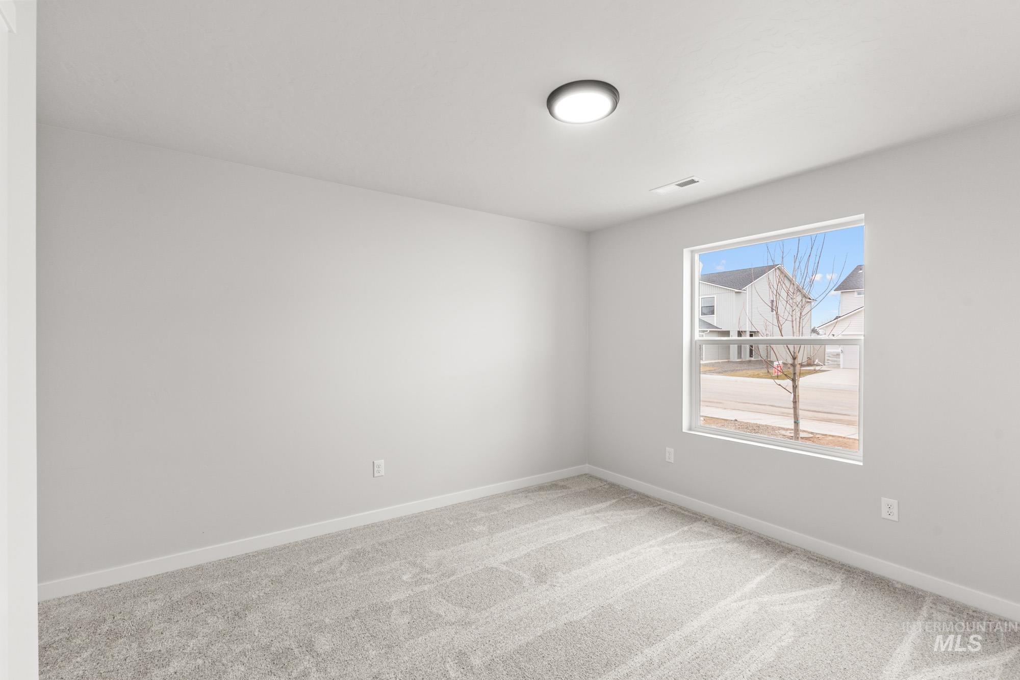 3030 South Maple Rnch Way Nampa, ID 83686 - Photo 10 of 21 Empty room featuring light carpet and baseboards