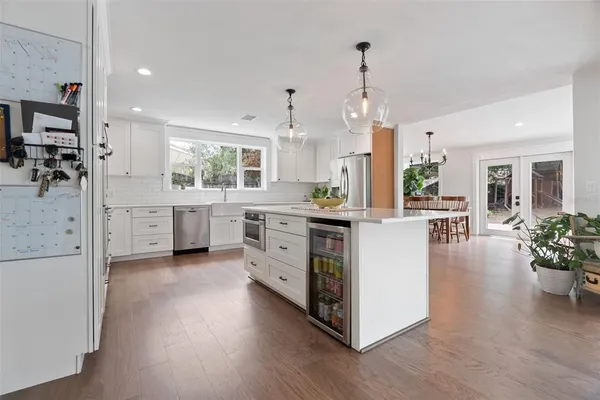 a kitchen with appliances cabinets and a sink