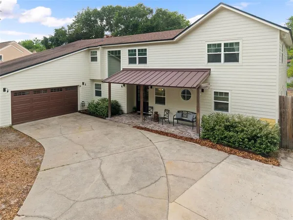a front view of a house with yard and porch