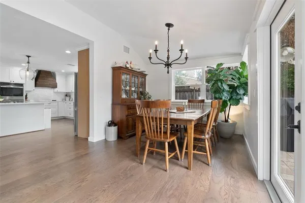 a view of a hallway with wooden floor and closet area