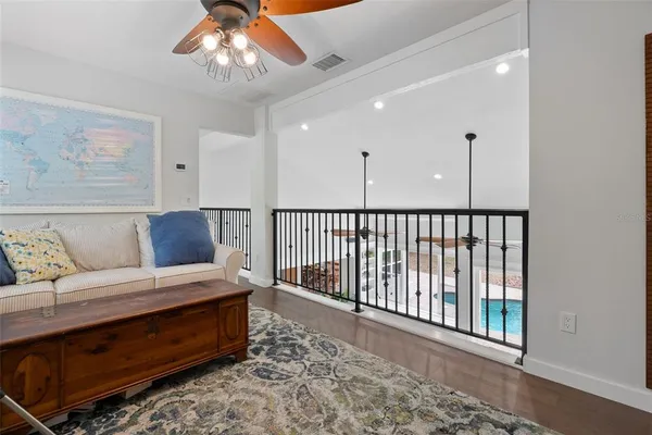 a living room with furniture and a painting on the wall