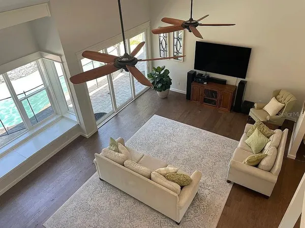 a kitchen with kitchen island white cabinets and stainless steel appliances