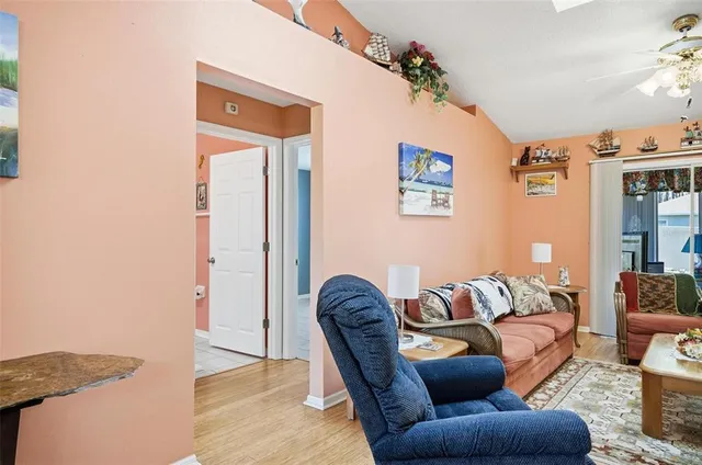 a living room with furniture and a potted plant