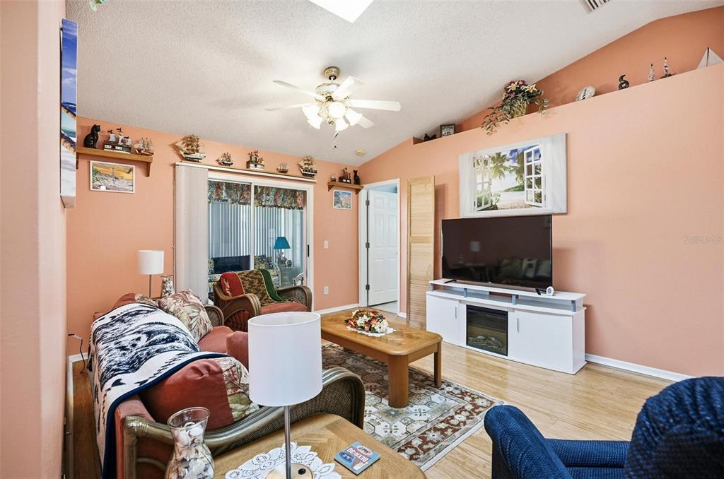 96 Ullian Trail Palm Coast, FL 32164 - Photo 17 of 42 a living room with furniture a flat screen tv and kitchen view