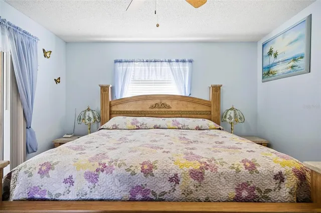 a bedroom with a bed and painting on the wall