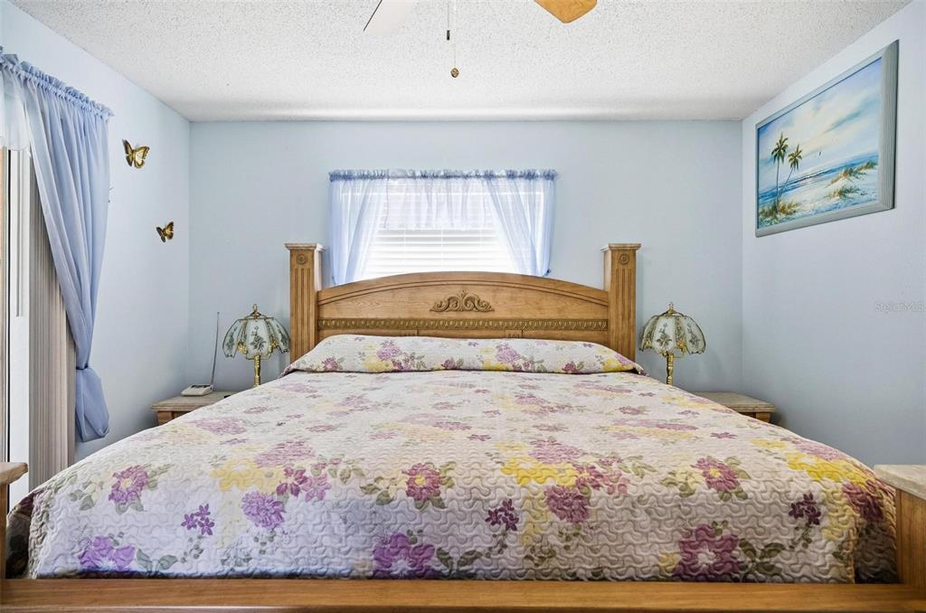 96 Ullian Trail Palm Coast, FL 32164 - Photo 20 of 42 a bedroom with a bed and painting on the wall