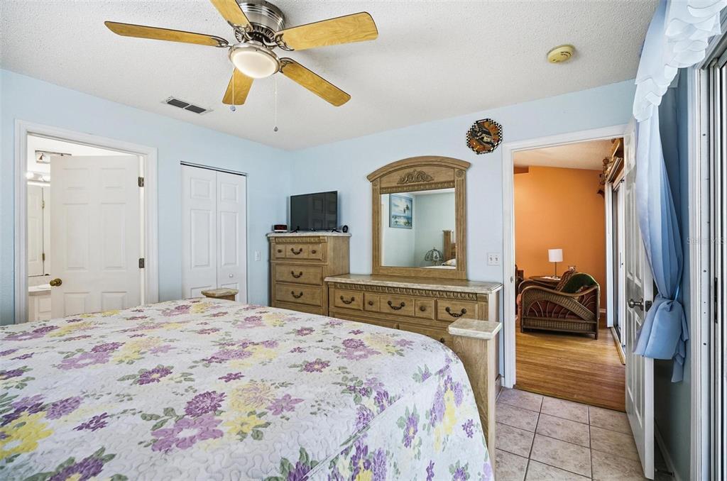 96 Ullian Trail Palm Coast, FL 32164 - Photo 21 of 42 a bedroom with a bed and a chandelier
