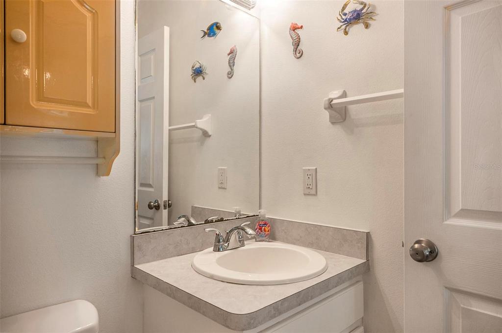 96 Ullian Trail Palm Coast, FL 32164 - Photo 25 of 42 a bathroom with a sink and mirror with toilet
