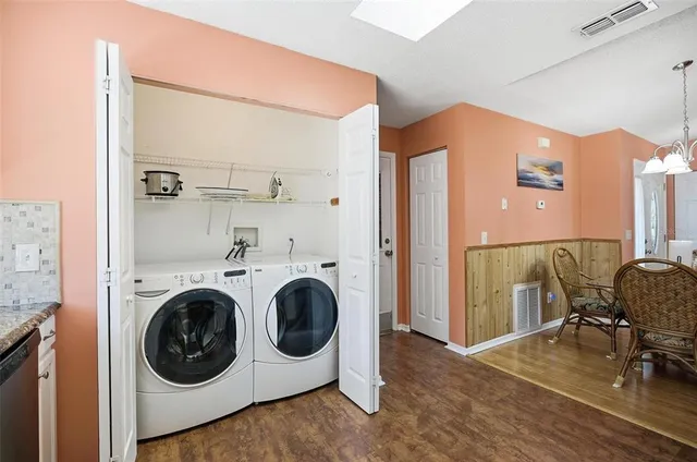 a view of a hallway with washer and dryer
