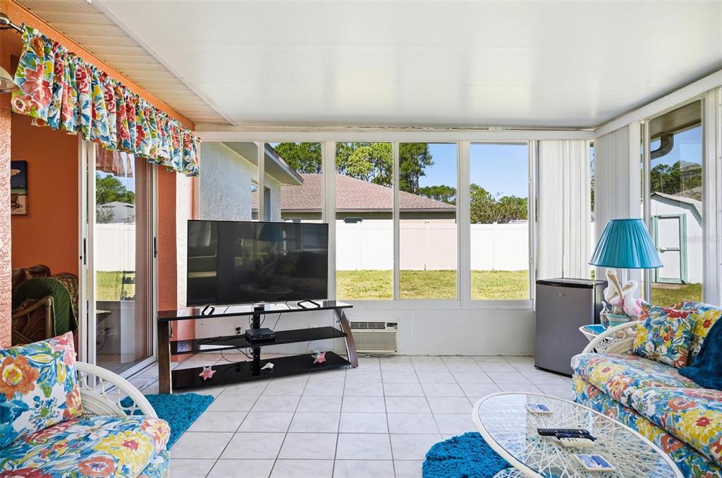 96 Ullian Trail Palm Coast, FL 32164 - Photo 34 of 42 a living room with furniture and a flat screen tv