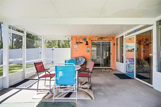 a dining room with furniture and large windows