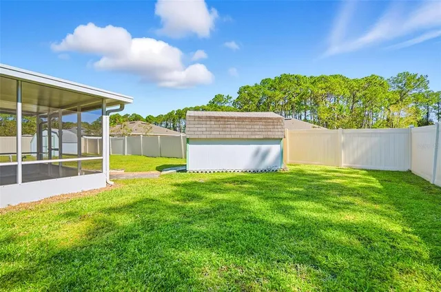 a view of a backyard with a garden and plants